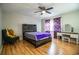 Bedroom featuring a rustic wood bed frame, vanity, ceiling fan, and wood floors at 3542 Raintree Ct, Lakeland, FL 33803