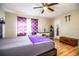 Bedroom with wood floors, a rustic bed frame, a vanity, and a wooden chest at 3542 Raintree Ct, Lakeland, FL 33803