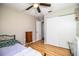Neutral-toned bedroom featuring a ceiling fan, hardwood floors, and ample closet space at 3542 Raintree Ct, Lakeland, FL 33803
