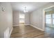 The dining room boasts laminate flooring, neutral walls, and flows to the kitchen allowing for easy entertaining and Gathering meals at 3542 Raintree Ct, Lakeland, FL 33803