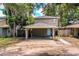 Two-story home featuring a spacious carport and welcoming blue front door at 3542 Raintree Ct, Lakeland, FL 33803