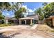 Charming two-story home with a carport, blue front door and well-kept yard at 3542 Raintree Ct, Lakeland, FL 33803