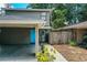 Charming two-story home with carport, blue door, and well-maintained landscaping at 3542 Raintree Ct, Lakeland, FL 33803