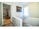Upstairs hallway featuring carpeted stairs, a window, neutral walls, and an open doorway at 3542 Raintree Ct, Lakeland, FL 33803