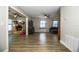 Spacious living room boasts hardwood floors, two ceiling fans, and adjacent room full of boxes at 3542 Raintree Ct, Lakeland, FL 33803