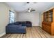 Living room featuring a comfortable, oversized blue sectional couch, hardwood floors, and a wooden china cabinet at 3542 Raintree Ct, Lakeland, FL 33803