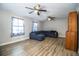 Living room with ceiling fans, a blue sofa, and abundant natural light from the windows at 3542 Raintree Ct, Lakeland, FL 33803