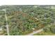 Aerial view showcasing the boundaries of a heavily wooded lot with mature trees and road access at 4035 K Ville Ave, Auburndale, FL 33823