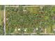 Aerial view showing the property boundaries of a heavily wooded lot surrounded by established neighborhoods at 4035 K Ville Ave, Auburndale, FL 33823