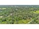 Aerial view of a heavily wooded lot, with surrounding rural residential properties and lush landscapes at 4035 K Ville Ave, Auburndale, FL 33823
