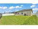 Spacious backyard featuring lush lawn, a fenced perimeter, and the home's exterior at 4143 Red Fern Ln, Lakeland, FL 33811