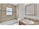 Well-lit bathroom featuring a shower-tub combo and a granite vanity top at 4143 Red Fern Ln, Lakeland, FL 33811