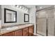 Bathroom features a double vanity and a modern shower with glass doors at 4143 Red Fern Ln, Lakeland, FL 33811
