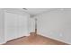 A bedroom features laminate floors, base trim, and a closet with paneled doors at 4143 Red Fern Ln, Lakeland, FL 33811