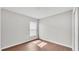 Bedroom with laminate wood floors, base trim, neutral walls, and a window at 4143 Red Fern Ln, Lakeland, FL 33811