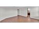Spacious bedroom with wood-look flooring leading to ensuite bathroom, offering a bright and airy feel at 4143 Red Fern Ln, Lakeland, FL 33811