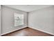 This cozy bedroom features wood flooring and a large window for natural light at 4143 Red Fern Ln, Lakeland, FL 33811
