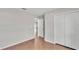 Bedroom with wood-look flooring and a hallway with access to closet with ample storage at 4143 Red Fern Ln, Lakeland, FL 33811