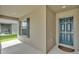 Inviting entryway showcases blue front door, window with shutters, and a cozy covered porch area at 4143 Red Fern Ln, Lakeland, FL 33811