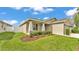 Well-maintained home featuring lush landscaping, a partial fence, and a welcoming covered porch at 4143 Red Fern Ln, Lakeland, FL 33811