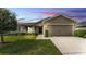 Charming single-story home featuring a manicured lawn, two-car garage, and covered entryway at 4143 Red Fern Ln, Lakeland, FL 33811
