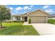 Charming single-story home featuring a manicured lawn, two-car garage, and covered entryway at 4143 Red Fern Ln, Lakeland, FL 33811