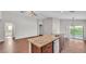 Large kitchen island featuring granite countertops and stainless steel appliances at 4143 Red Fern Ln, Lakeland, FL 33811