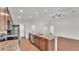 Open kitchen with stainless steel appliances and a large center island at 4143 Red Fern Ln, Lakeland, FL 33811