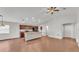Open-concept kitchen with wood cabinets, breakfast bar, and a spacious living area at 4143 Red Fern Ln, Lakeland, FL 33811