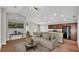 Open-concept living space featuring wood floors, vaulted ceilings, and a breakfast bar with granite countertops at 4143 Red Fern Ln, Lakeland, FL 33811