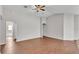 Open-concept living space showing the vinyl floors, neutral-color walls, and door leading to the bathroom at 4143 Red Fern Ln, Lakeland, FL 33811