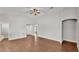 Bright, open living room with wood-look floors and a ceiling fan at 4143 Red Fern Ln, Lakeland, FL 33811