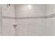 Close up of tiled shower showcasing neutral colored tiling and a small inset shelf at 4143 Red Fern Ln, Lakeland, FL 33811