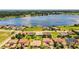 Stunning aerial view of a lakeside home with lush landscaping, highlighting its prime waterfront location at 4222 Juliana Lake Dr, Auburndale, FL 33823