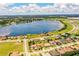 An aerial view of a house with lake access and surrounding residential area, with blue lake at 4222 Juliana Lake Dr, Auburndale, FL 33823