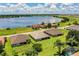 Aerial view of waterfront homes, featuring green lawns, mature trees, and a large blue lake at 4222 Juliana Lake Dr, Auburndale, FL 33823