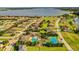 An aerial view of a residential area with a pool, tennis court, and a large lake at 4222 Juliana Lake Dr, Auburndale, FL 33823