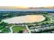 Breathtaking aerial view of a lakeside community at sunset, showcasing the neighborhood's scenic beauty at 4222 Juliana Lake Dr, Auburndale, FL 33823