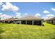 Beautiful home featuring a well-maintained lawn and a spacious screened patio, perfect for outdoor enjoyment at 4222 Juliana Lake Dr, Auburndale, FL 33823