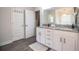 Spacious bathroom featuring double vanity, granite countertop, and modern wood-look flooring at 4222 Juliana Lake Dr, Auburndale, FL 33823