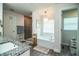 Bathroom showcasing double vanity, granite countertops, soaking tub, and tiled walk-in shower at 4222 Juliana Lake Dr, Auburndale, FL 33823