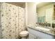 Well-appointed bathroom with a butterfly shower curtain and a granite-topped vanity at 4222 Juliana Lake Dr, Auburndale, FL 33823