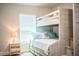 Charming bedroom featuring a bunk bed with a sturdy staircase and soft blue accents at 4222 Juliana Lake Dr, Auburndale, FL 33823