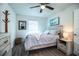 Cozy bedroom featuring a large bed, natural light, and stylish decor with wood-look flooring at 4222 Juliana Lake Dr, Auburndale, FL 33823