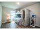 Well-lit bedroom featuring a bunk bed with built-in stairs and a decorative bookshelf at 4222 Juliana Lake Dr, Auburndale, FL 33823