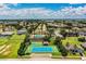 Scenic aerial view showcasing the community pool and tennis courts surrounded by manicured landscaping at 4222 Juliana Lake Dr, Auburndale, FL 33823