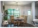 Cozy dining area with round table, wood chairs, decorative lighting, and natural light at 4222 Juliana Lake Dr, Auburndale, FL 33823