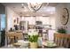 Open-concept dining area with views into the kitchen, a round table, and stylish light fixture at 4222 Juliana Lake Dr, Auburndale, FL 33823