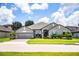 Beautiful single-Gathering home featuring a well-maintained lawn, a two-car garage and mature landscaping at 4222 Juliana Lake Dr, Auburndale, FL 33823