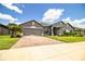 Beautiful single Gathering home with a well-manicured lawn, paved driveway, and attached garage at 4222 Juliana Lake Dr, Auburndale, FL 33823